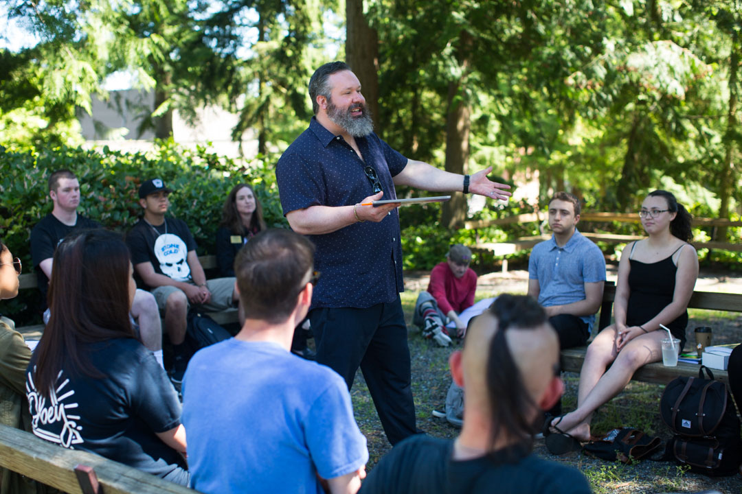 Social Sciences and Public Service Pathway students sitting outside listening to instructor